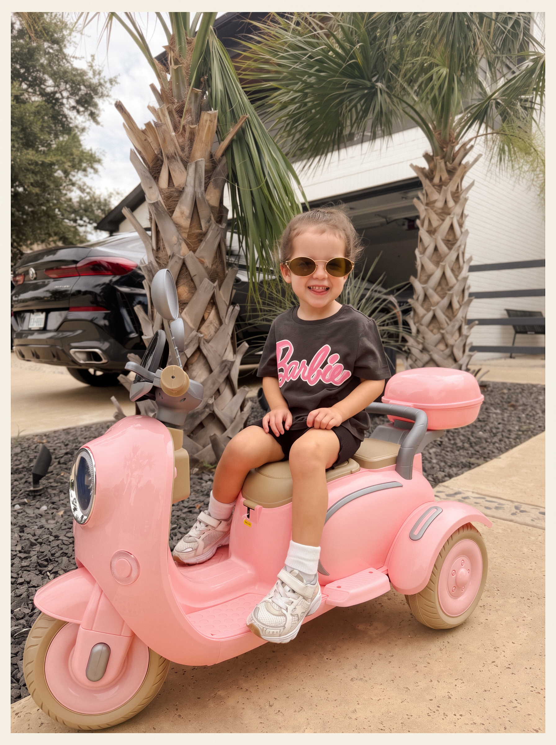 Paisley Rae on her pink scooter